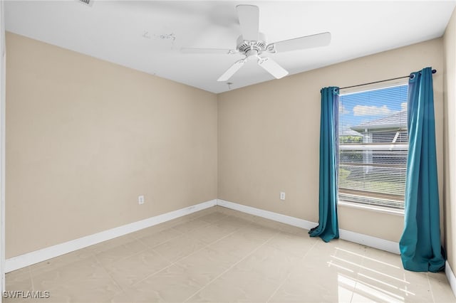 3206 8th St SW, Lehigh Acres, FL 33976 - unfurnished room with baseboards and a ceiling fan