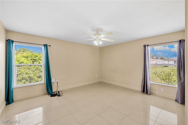 3206 8th St SW, Lehigh Acres, FL 33976 - empty room with plenty of natural light, a ceiling fan, and light tile patterned floors