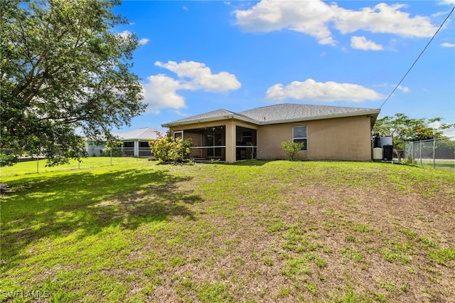 3206 8th St SW, Lehigh Acres, FL 33976 - rear view of property featuring a sunroom and stucco siding