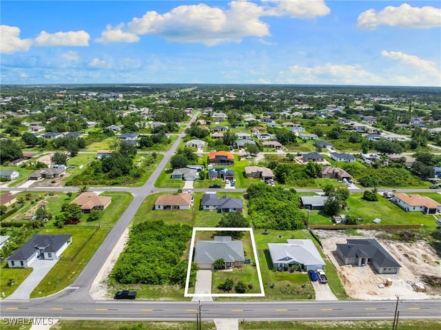 3206 8th St SW, Lehigh Acres, FL 33976 - aerial perspective of suburban area featuring property parcel outlined