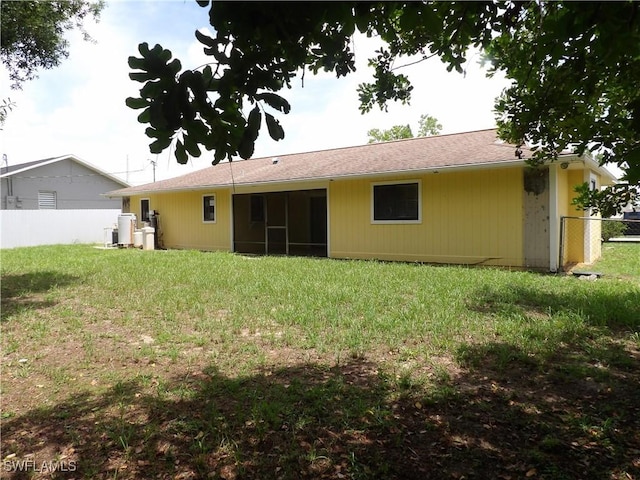 4807 6th St W, Lehigh Acres, FL 33971 - rear view of property featuring a sunroom