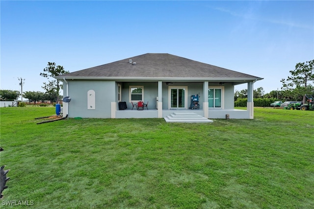 9785 Wheeler Rd, Labelle, FL 33935 - rear view of property featuring a patio, a ceiling fan, stucco siding, a lawn, and roof with shingles