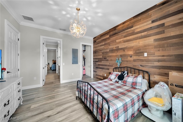 9785 Wheeler Rd, Labelle, FL 33935 - bedroom featuring wooden walls, ornamental molding, a chandelier, light wood-type flooring, and electric panel