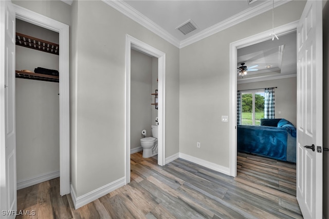 9785 Wheeler Rd, Labelle, FL 33935 - bedroom with attic access, wood finished floors, ornamental molding, and connected bathroom