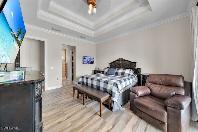 9785 Wheeler Rd, Labelle, FL 33935 - bedroom featuring a raised ceiling, light wood-type flooring, ornamental molding, and a walk in closet