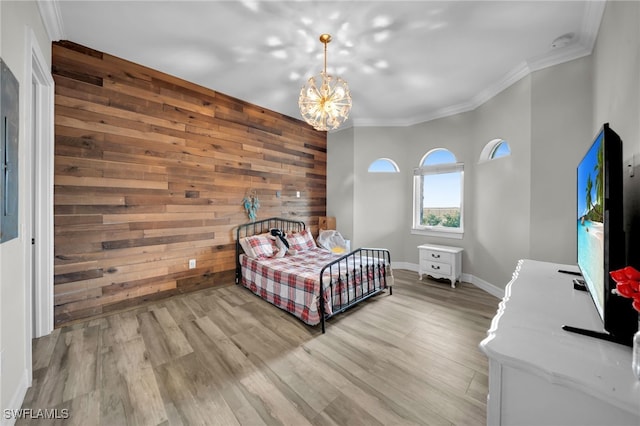 9785 Wheeler Rd, Labelle, FL 33935 - bedroom featuring wood walls, crown molding, a chandelier, and light wood-style floors