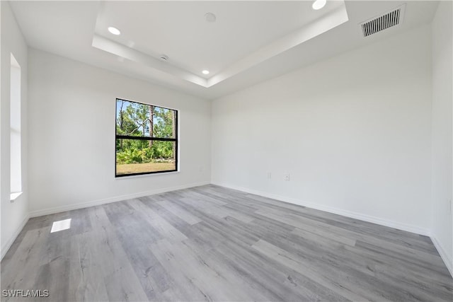 2912 8th St W, Lehigh Acres, FL 33971 - unfurnished room featuring recessed lighting, a tray ceiling, and wood finished floors