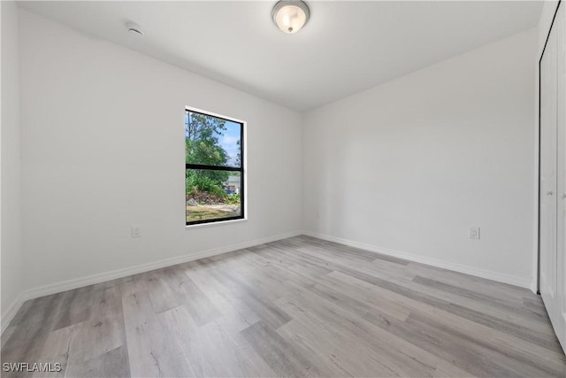 2912 8th St W, Lehigh Acres, FL 33971 - spare room with light wood-style flooring and baseboards