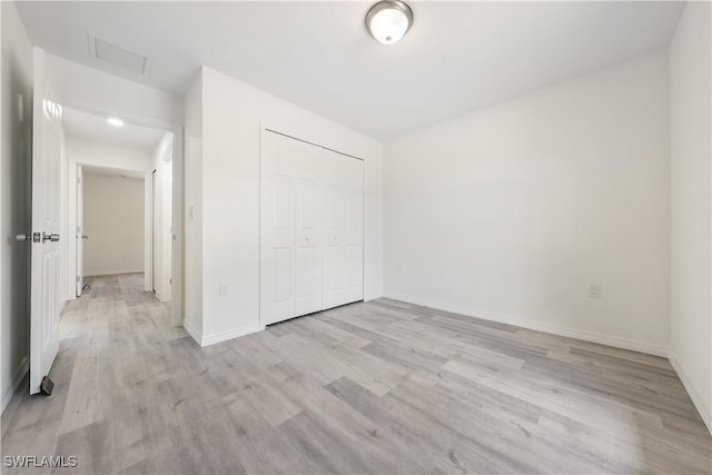 2912 8th St W, Lehigh Acres, FL 33971 - unfurnished bedroom with light wood finished floors and a closet