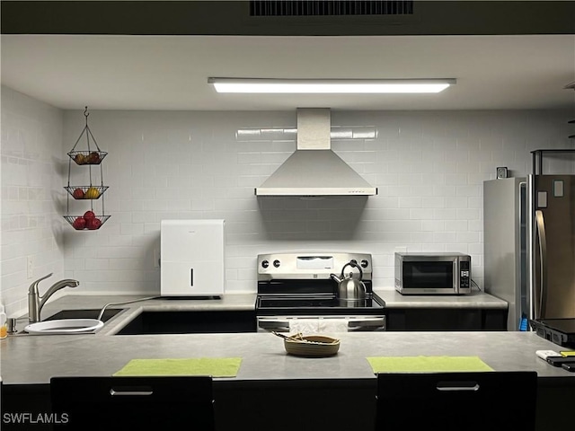 1900 Clifford St Unit 606, Fort Myers, FL 33901 - kitchen with wall chimney exhaust hood, appliances with stainless steel finishes, light countertops, and tasteful backsplash