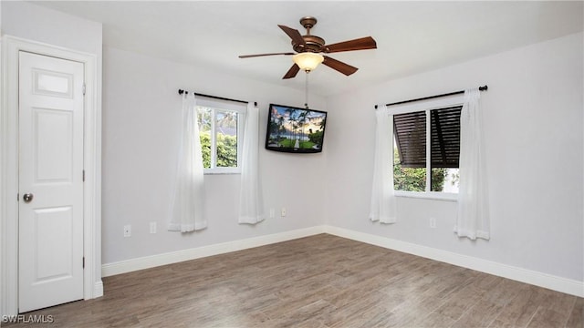 27978 Carl Cir, Bonita Springs, FL 34135 - spare room with wood finished floors and a ceiling fan