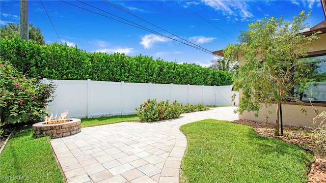 27978 Carl Cir, Bonita Springs, FL 34135 - fenced backyard featuring a fire pit and a patio