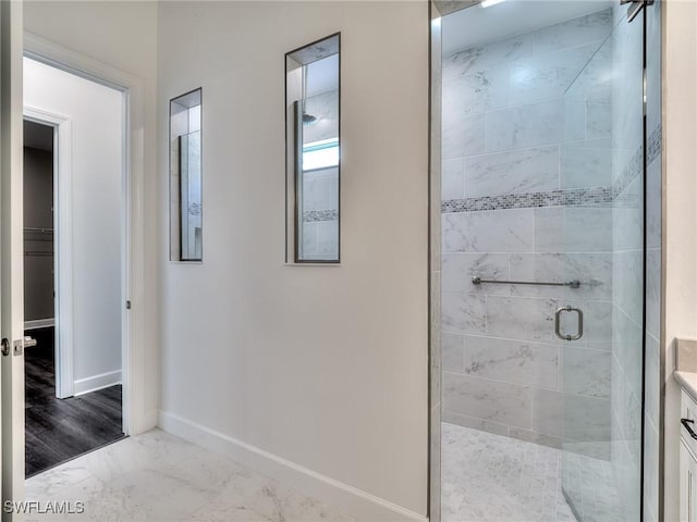 6992 Chapel Creek Ln, North Fort Myers, FL 33917 - full bath featuring a shower stall, marble look tiles, a walk in closet, and vanity