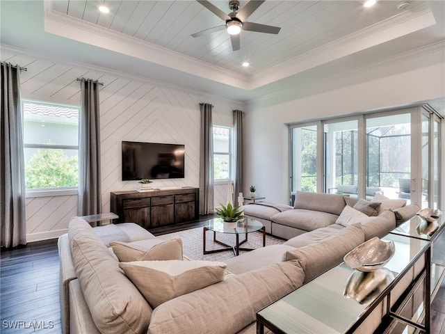 6992 Chapel Creek Ln, North Fort Myers, FL 33917 - living room with dark wood-style flooring, a tray ceiling, healthy amount of natural light, and ornamental molding