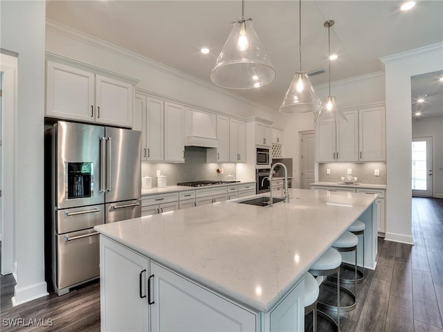6992 Chapel Creek Ln, North Fort Myers, FL 33917 - kitchen with appliances with stainless steel finishes, custom exhaust hood, dark wood-type flooring, white cabinetry, and ornamental molding