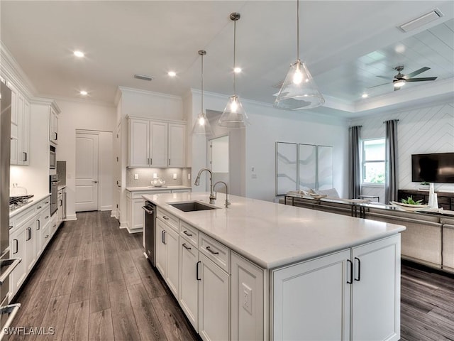 6992 Chapel Creek Ln, North Fort Myers, FL 33917 - kitchen featuring open floor plan, dark wood-type flooring, crown molding, white cabinets, and a kitchen island with sink