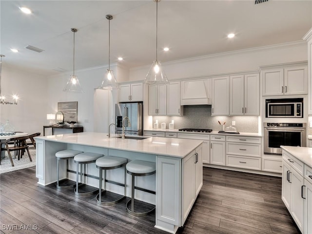 6992 Chapel Creek Ln, North Fort Myers, FL 33917 - kitchen featuring appliances with stainless steel finishes, premium range hood, white cabinetry, decorative backsplash, and light countertops