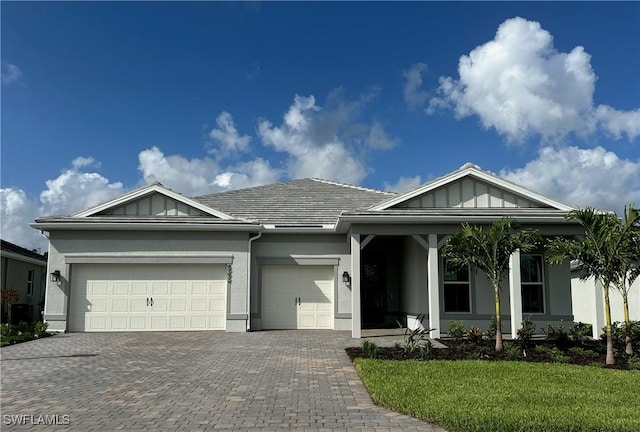 6992 Chapel Creek Ln, North Fort Myers, FL 33917 - ranch-style home featuring an attached garage, decorative driveway, stucco siding, and a front lawn