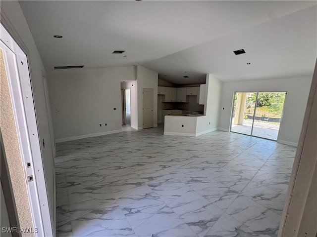 712 Oakridge Ave S, Lehigh Acres, FL 33974 - unfurnished living room featuring light marble finish floors, vaulted ceiling, and recessed lighting