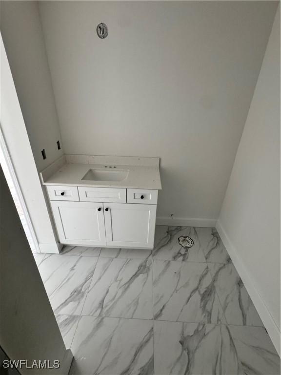 712 Oakridge Ave S, Lehigh Acres, FL 33974 - bathroom with marble finish flooring and vanity