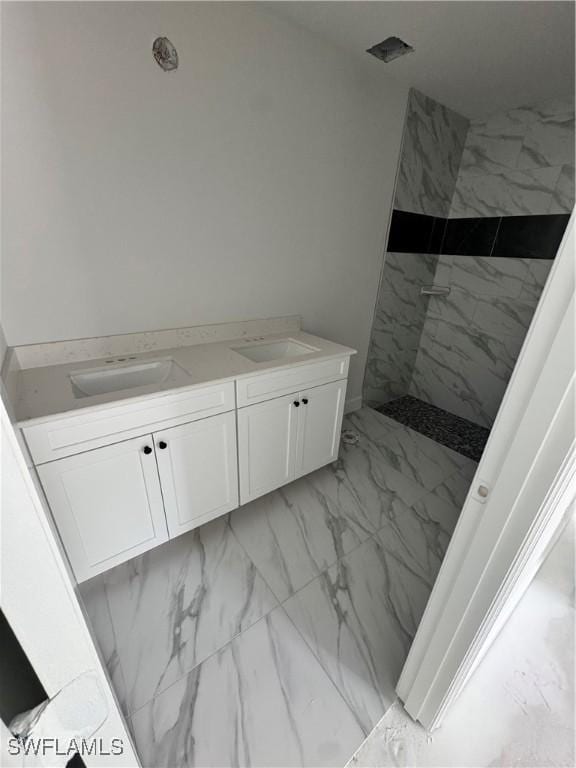 712 Oakridge Ave S, Lehigh Acres, FL 33974 - bathroom with marble look tiles, a marble finish shower, and double vanity
