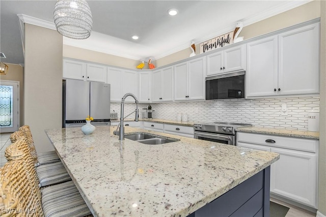 19545 Utopia Ln, Estero, FL 33928 - kitchen with stainless steel appliances, decorative backsplash, a breakfast bar area, light stone counters, and a kitchen island with sink