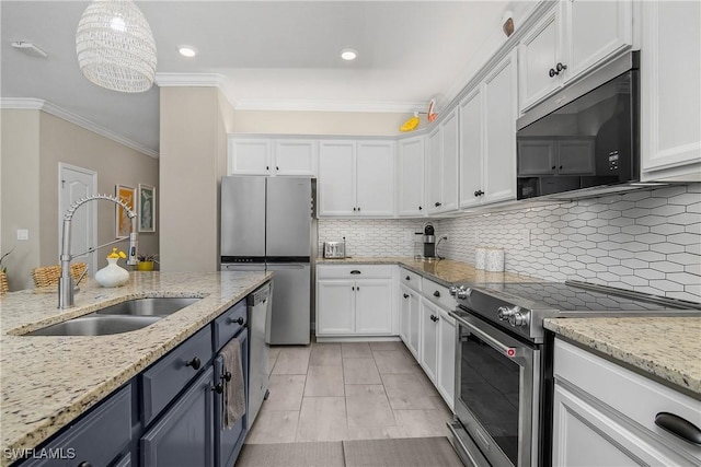 19545 Utopia Ln, Estero, FL 33928 - kitchen with appliances with stainless steel finishes, crown molding, white cabinets, tasteful backsplash, and recessed lighting