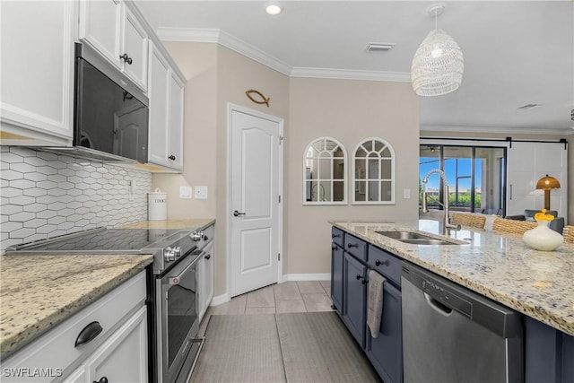 19545 Utopia Ln, Estero, FL 33928 - kitchen featuring stainless steel appliances, white cabinetry, tasteful backsplash, light stone countertops, and crown molding
