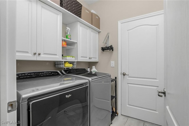 19545 Utopia Ln, Estero, FL 33928 - laundry room featuring washing machine and dryer, cabinet space, and light tile patterned flooring