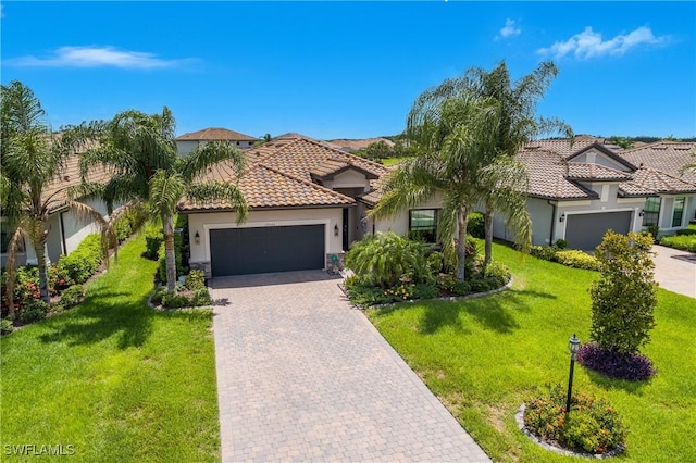 19545 Utopia Ln, Estero, FL 33928 - mediterranean / spanish-style home featuring a garage, stucco siding, decorative driveway, and a tile roof