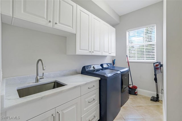 9053 Cascada Way Unit 202, Naples, FL 34114 - laundry room with cabinet space, washing machine and clothes dryer, and light tile patterned floors