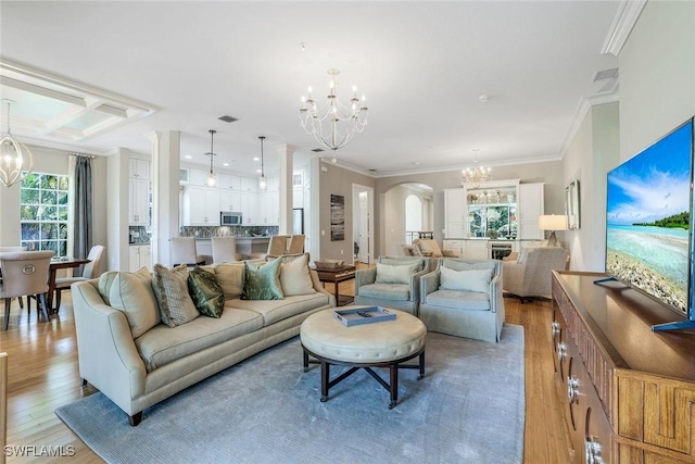9053 Cascada Way Unit 202, Naples, FL 34114 - living area featuring a chandelier, light wood-type flooring, arched walkways, crown molding, and coffered ceiling