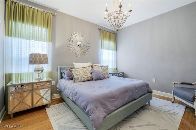 9053 Cascada Way Unit 202, Naples, FL 34114 - bedroom featuring a chandelier and wood finished floors