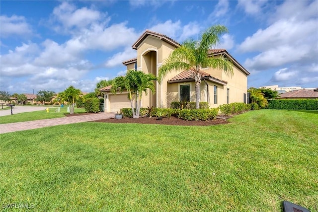 2738 Via Piazza Loop, Fort Myers, FL 33905 - mediterranean / spanish house with a tiled roof, decorative driveway, stucco siding, and a front yard