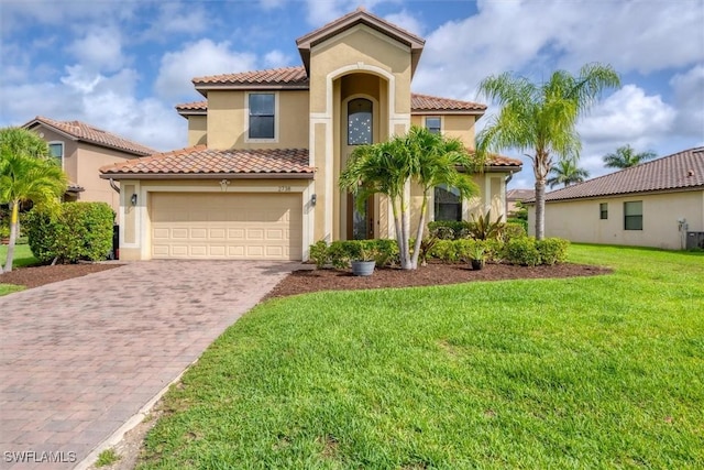 2738 Via Piazza Loop, Fort Myers, FL 33905 - mediterranean / spanish house with driveway, a tiled roof, stucco siding, a front lawn, and a garage