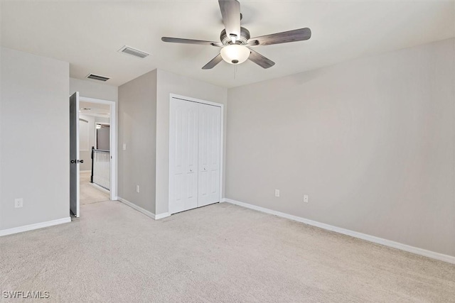 2738 Via Piazza Loop, Fort Myers, FL 33905 - unfurnished bedroom with light colored carpet, a closet, and a ceiling fan