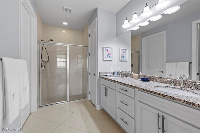 20147 Torch Key Way, Estero, FL 33928 - bathroom featuring double vanity, a stall shower, and tile patterned floors