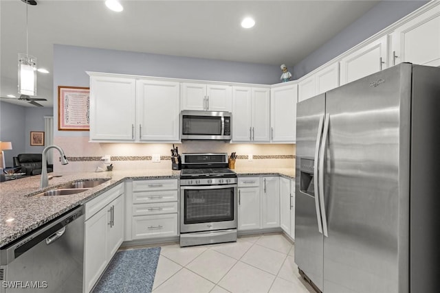20147 Torch Key Way, Estero, FL 33928 - kitchen featuring stainless steel appliances, white cabinetry, recessed lighting, light stone counters, and light tile patterned floors