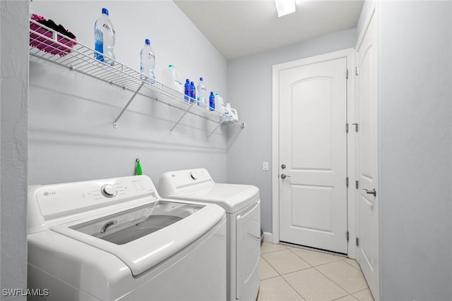 20147 Torch Key Way, Estero, FL 33928 - laundry area featuring washer and dryer and light tile patterned floors