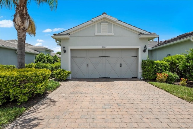 20147 Torch Key Way, Estero, FL 33928 - garage featuring decorative driveway