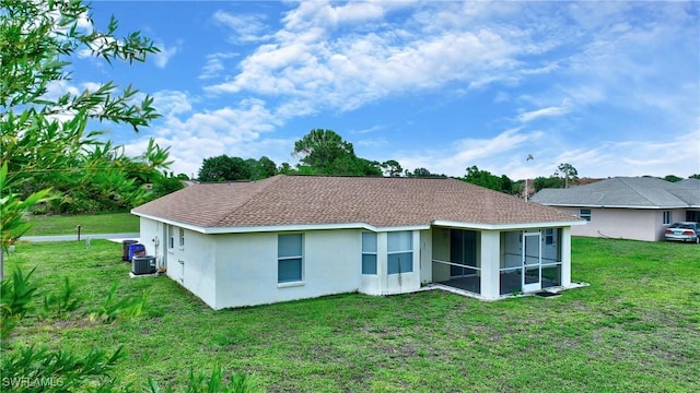 1612 Covington Meadows Cir, Lehigh Acres, FL 33936 - back of house featuring stucco siding, a lawn, and a sunroom