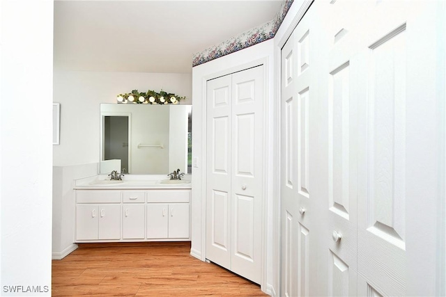 1612 Covington Meadows Cir, Lehigh Acres, FL 33936 - bathroom with a closet, double vanity, and wood finished floors