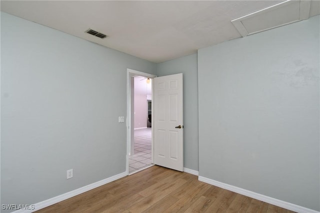 1612 Covington Meadows Cir, Lehigh Acres, FL 33936 - empty room featuring light wood-style floors and attic access