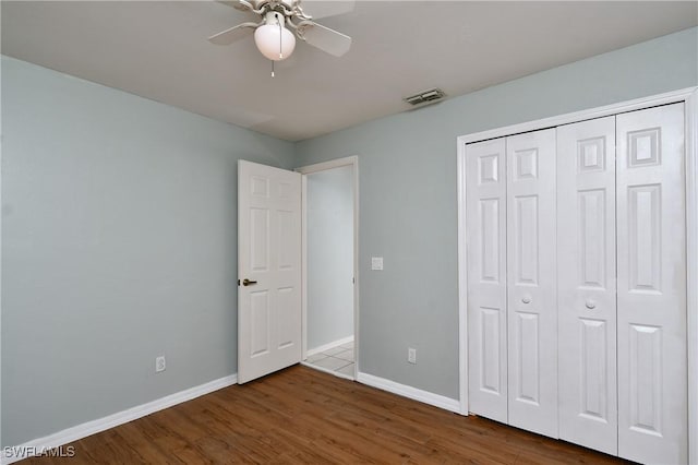 1612 Covington Meadows Cir, Lehigh Acres, FL 33936 - unfurnished bedroom with wood finished floors, a closet, and ceiling fan