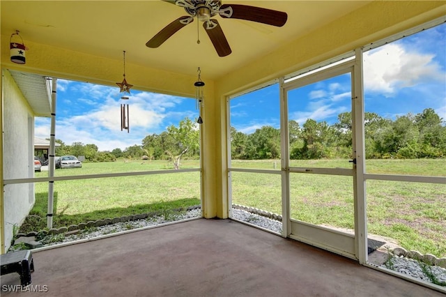 1612 Covington Meadows Cir, Lehigh Acres, FL 33936 - unfurnished sunroom featuring a ceiling fan and view of scattered trees