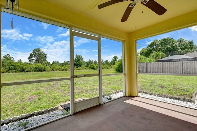1612 Covington Meadows Cir, Lehigh Acres, FL 33936 - unfurnished sunroom featuring ceiling fan and view of wooded area