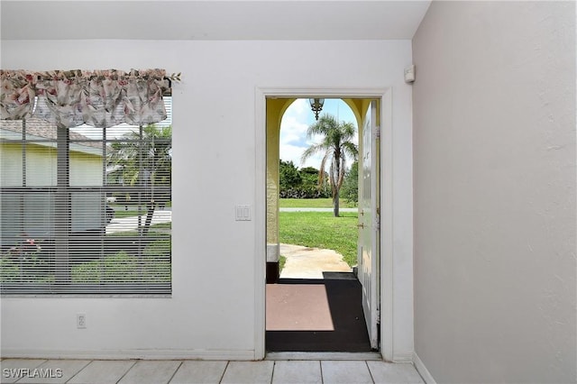 1612 Covington Meadows Cir, Lehigh Acres, FL 33936 - doorway to outside with light tile patterned floors and baseboards