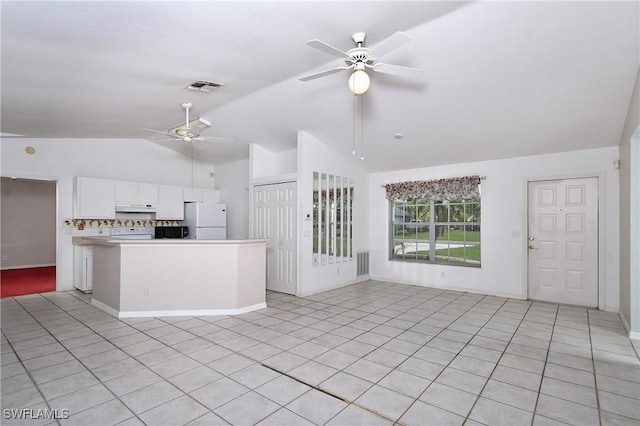 1612 Covington Meadows Cir, Lehigh Acres, FL 33936 - kitchen with white appliances, a ceiling fan, vaulted ceiling, white cabinets, and light tile patterned floors