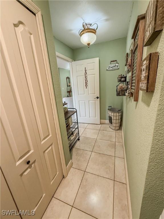 1700 E 15th St, Lehigh Acres, FL 33972 - hall with light tile patterned flooring