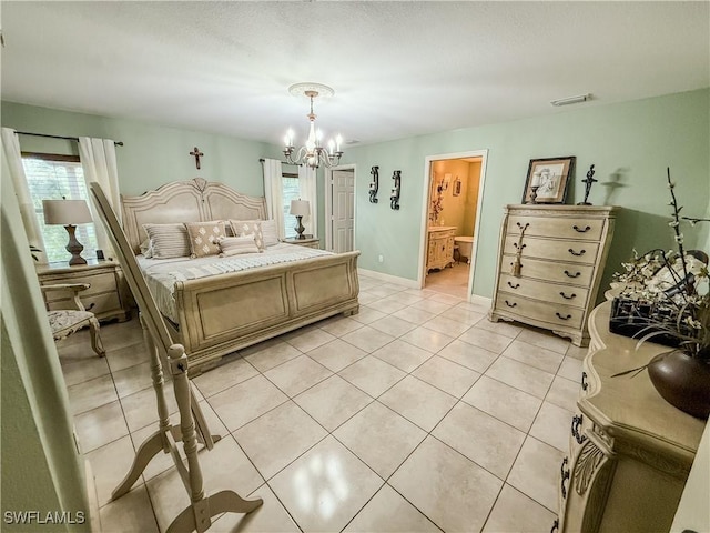 1700 E 15th St, Lehigh Acres, FL 33972 - bedroom featuring a chandelier, light tile patterned floors, and connected bathroom